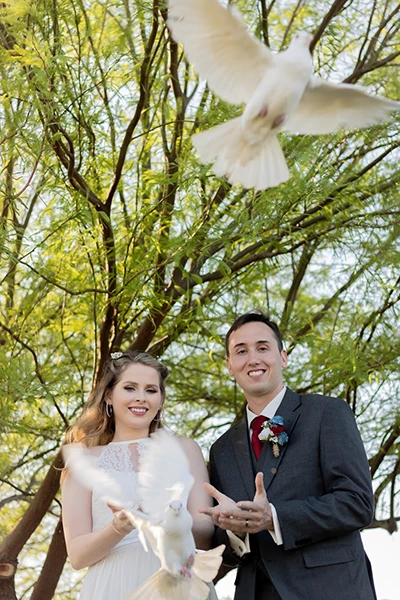 Wedding couple releases two white doves